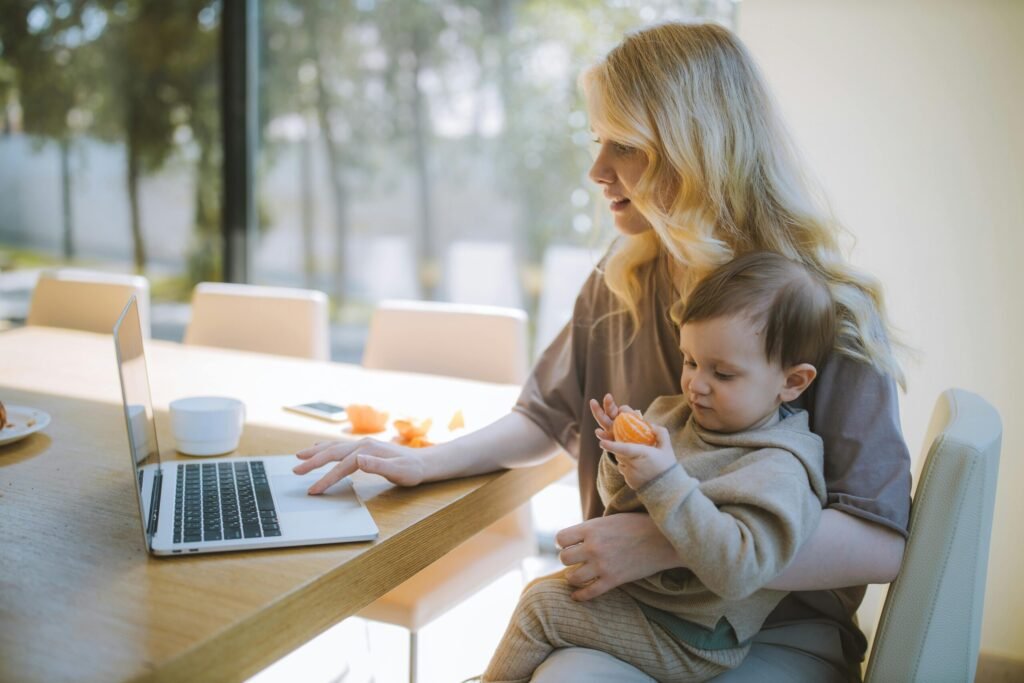 A woman holding a child while working.